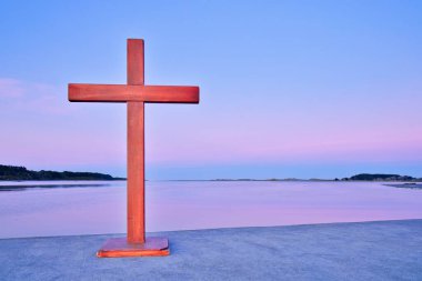 Ahşap Haç iskelede güneş ufuk çizgisini aydınlatırken.