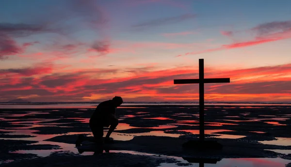 Cruz de marea baja Orando —  Fotos de Stock