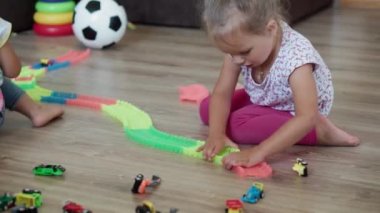 Çocukluk, oyunlar, yetiştirme ve geliştirme konsepti. Küçük çocukların genel planı. Erkek ve kız kardeş kardeş, çocuk oyun odasında sihirli yollarla oynuyor. Kardeşler karantinada eğleniyor.