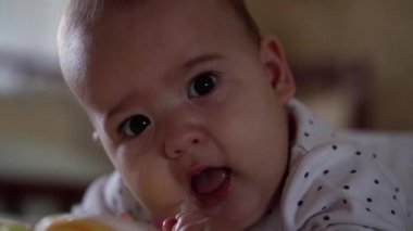 bebeklik, çocukluk, ebeveynlik, gelişim, tıp ve sağlık konsepti - önden görüş, yeni doğmuş bebek tombul bebek, pembe bedenli neşeli uyanıklık, göbeğinde çok renkli oyuncaklarla gülümsüyor