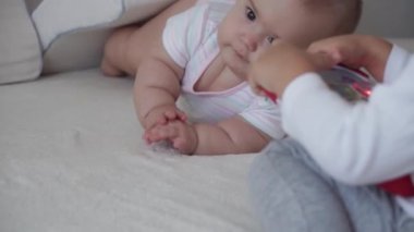 Aile, çocukluk, bebek konseptleri iki yeni doğmuş bebek ve erkek çocuk yatakta oyuncaklarla oynuyorlar. Kardeşler küçük erkek ve kız kardeşler evde karantinada eğleniyor ve gülüyorlar..