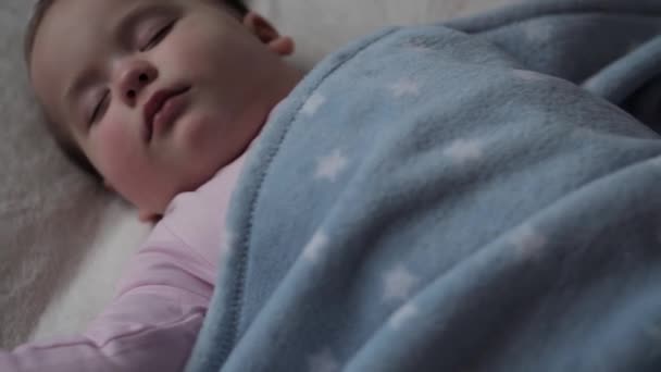 Infancy, Relaxation, Sweet Dreams, Childhood, Family Concept - Chubby cute face tiny hand of Little 9-12 months Old Baby child kid girl Sleep on white Bed Covered in Blanket in Lunchtime Sleep Mode — Stock Video