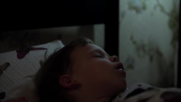 Relaxation, Sweet Dreams, Childhood, Family Concepts - Tight close up Little 2-3 Year Old preschool minor toddler wet Baby boy lie on white Bed Covered in Blanket in Dark Room during night sleep mode — Stock Video