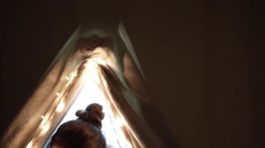 Otantik sevimli anne ve anaokulu çocukları evdeki çadırda kız ve erkek. Genç bir kadın 2-4 yaşlarındaki çocuklara kitap okurdu. Aile, Çocukluk, Annelik, Rahatlık ve Güvenlik kavramı