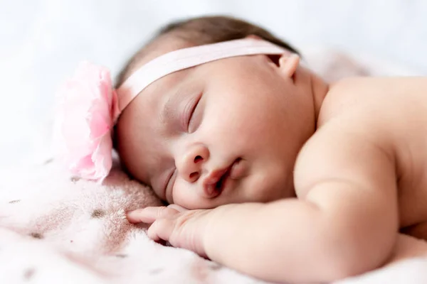 Childhood, care, motherhood, health, medicine, pediatrics concepts - Close up Little peace calm naked infant newborn baby girl in pink hat sleeps resting take deep nap laying on tummy on soft bed — Stock Photo, Image