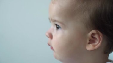 Otantik, beyaz, küçük, beyaz, tombul kız bebek uykulu uyanır uyanmaz oyuncak ayı beyaz yatakta kameraya bakar. Çocuk bakımı, uyuyan çocuk, çocukluk, ebeveynlik, hayat konsepti.