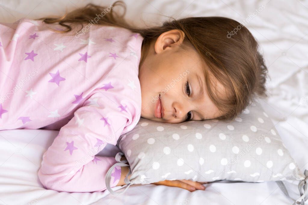 home, comfort, childhood, care, love, sweet dream- little pretty smiling happy authentic toddler sibling kid child girl in pajamas lie rest sleep on bed pillows with closed eyes soft cozy sleepy mood