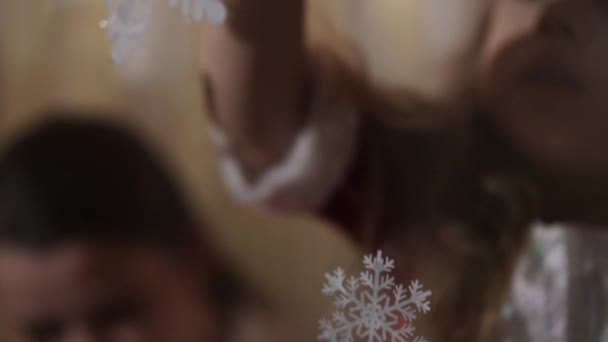 Autentické roztomilé maminka a dvě malé školky nezletilé děti sourozenci dívka a chlapec 2-4 let čerpat vánoční stromek na okno. mladá žena s dětmi lepí sněhové vločky. Vánoce, Nový rok, zimní koncept. — Stock video