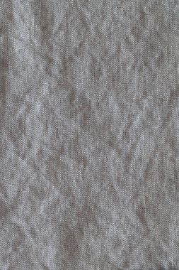 Kırışık keten kumaş arka planının en üst görüntüsü. Çay havlusu, peçete, masa örtüsü ya da giysi yakın plan. Basitlik kavramı, çevre dostluğu, doğal giysiler, ev yapımı tekstil. Dikey.