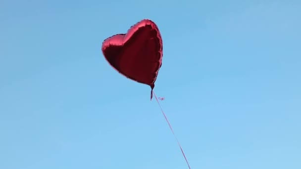 Red Foil Balloon Shape Heart Filled Helium Flies Backdrop Cloudless — Stock Video