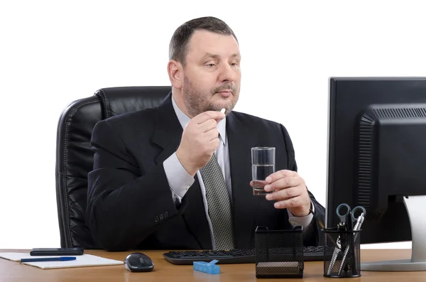 Man in the office takes pill during virtual doctor visit — Stock Photo, Image