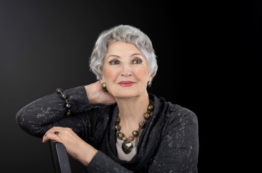 Portrait of senior woman with tiger iron eye beads set