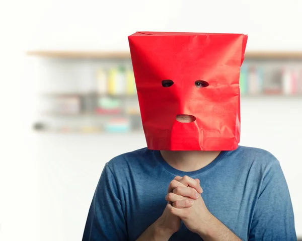 Shy guy in red paper bag feels awkward — Stock Photo, Image