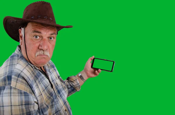 Old Farmer Looks Camera Disbelief Smartphone Green Chroma Key Screen — Stock Photo, Image