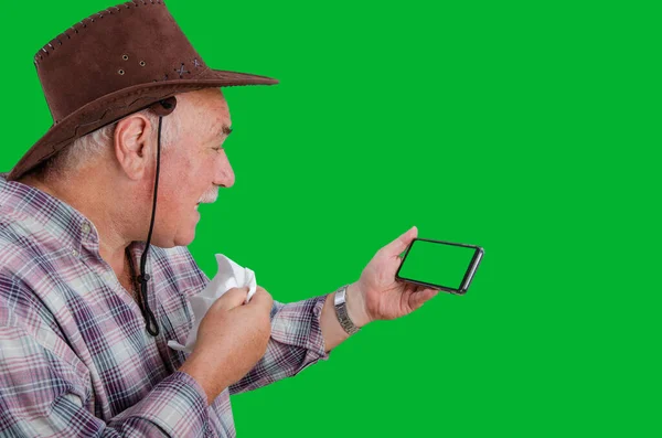 A country man is happy that the virus has not been confirmed. He got the result on the green chroma key screen of the smartphone. Telemedicine topic