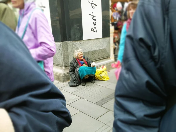 Old grey-haired woman beggar — Stock Photo, Image