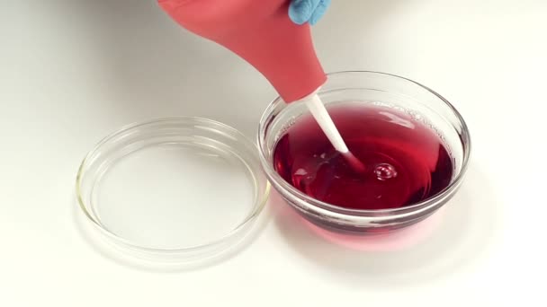 Rectal bulb syringe is filling with red liquid — Stock Video