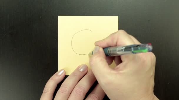 Drawing smiley face Laughing on note paper — Stock Video