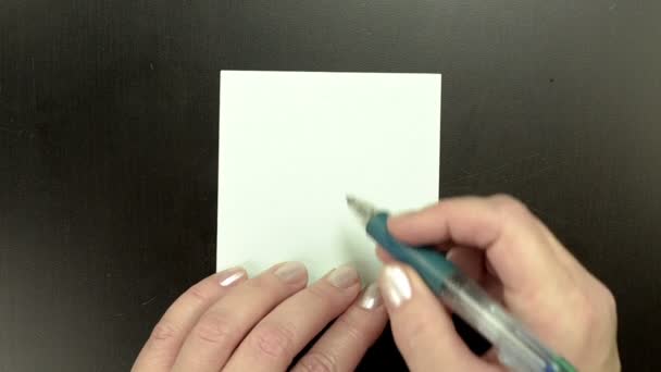 Drawing smiley face Winking on note paper
