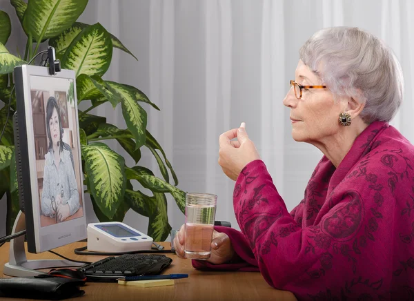 Taking pill during virtual medical practitioner visit — Stock Photo, Image