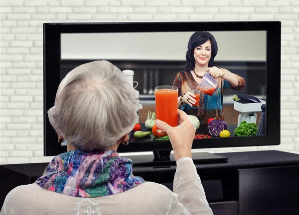 Old woman toasting with detox smoothie — Stock Photo, Image