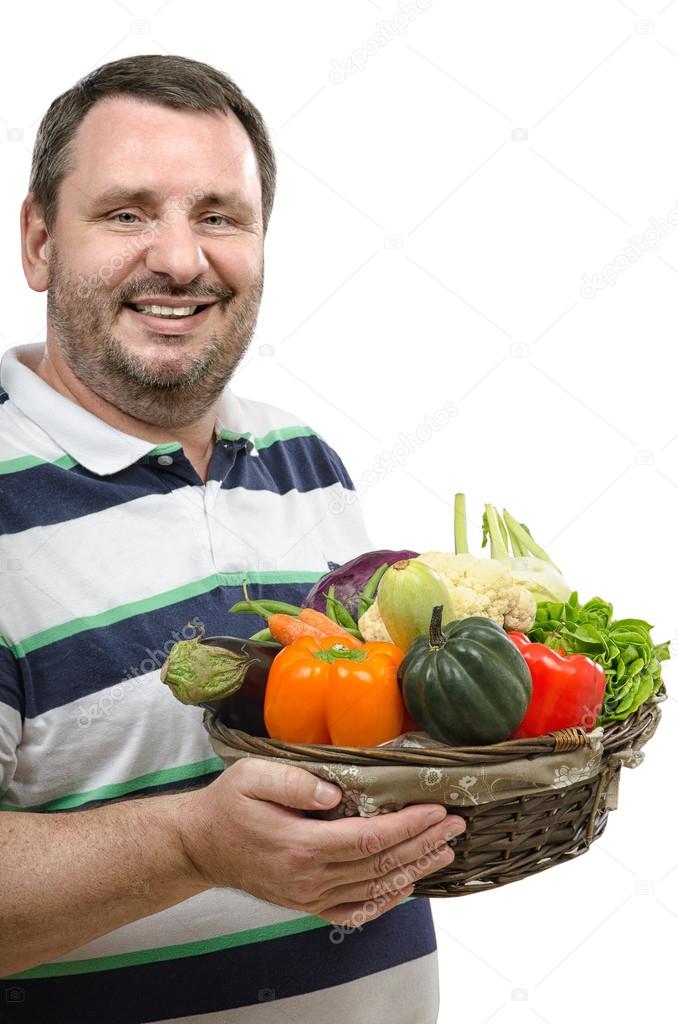 Smiling retailer with a basket of vegetables