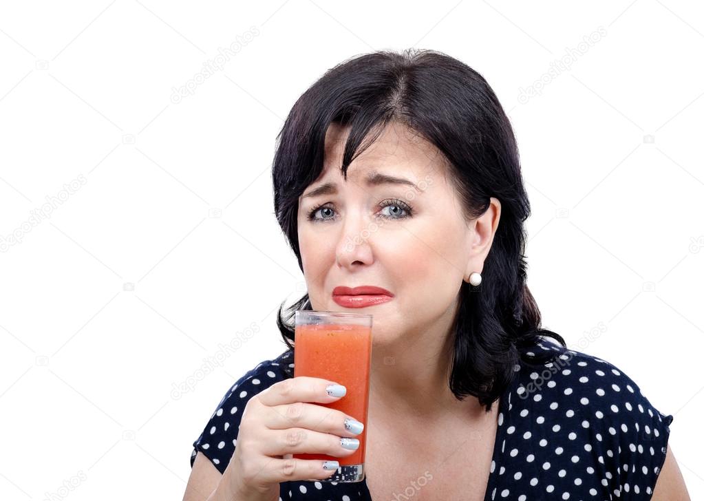 Crying woman is filled with disgust by detox drink