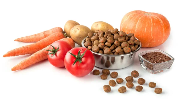 Dog or cat food on stainless dish with raw vegetables on white background for design about pet shop.