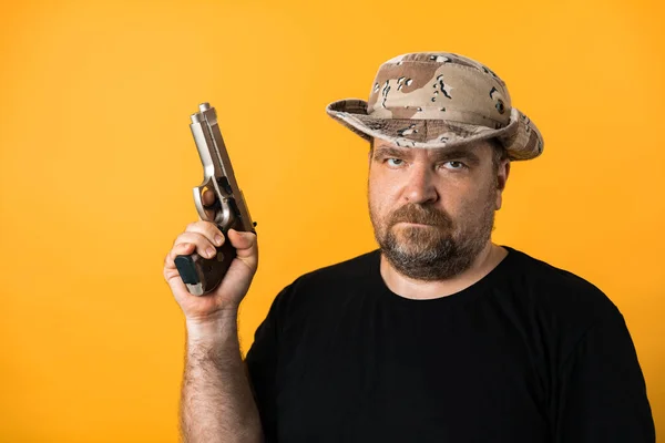 Middle Aged Man Gun Black Shirt Hat Yellow Background — Stock Photo, Image