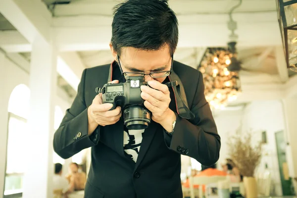 Photographer man take photo of latte coffee in cafe