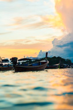 Balıkçı teknesi sahil siluet günbatımı hafif renkli bulut