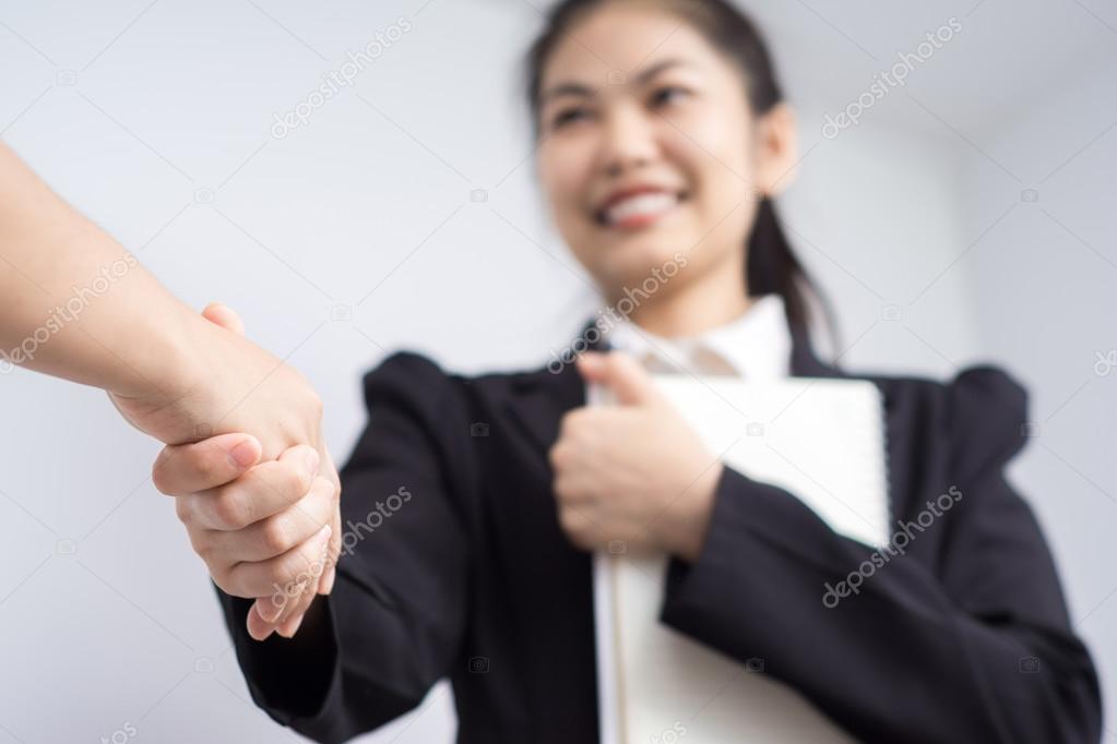 Businesswoman Shaking Hands In Office
