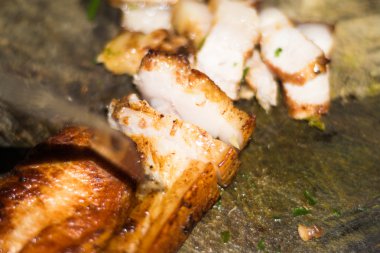 Eski kesme tahtası üzerinde kavrulmuş domuz eti