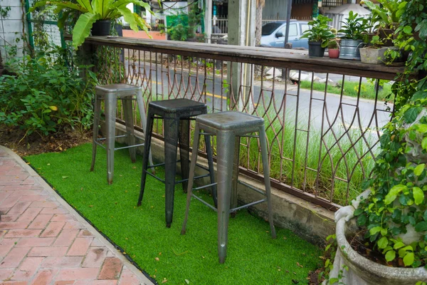 table and chairs in park outdoor at cafe and hang out bar