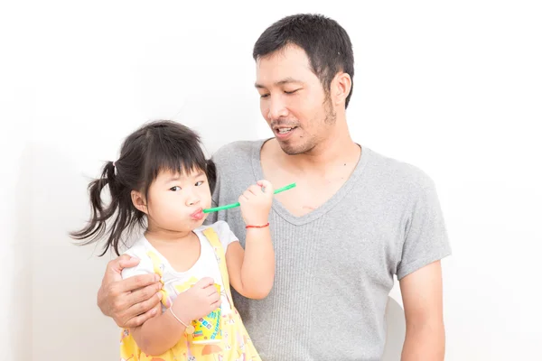 アジアの女の子はジュースを飲むと 白い背景の上の彼女の父を抱き締める — ストック写真