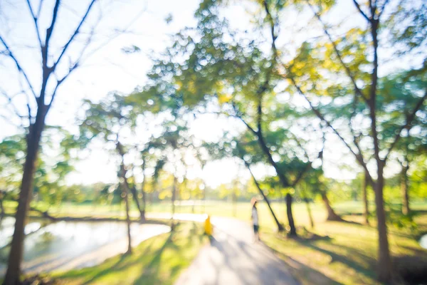 Defocused beautiful sun light at park with people exercise, Healthy work out