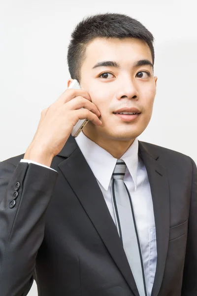 Όμορφος επιχείρηση Ασίας άνθρωπος σε μαύρο κοστούμι μιλώντας στο τηλέφωνο — Φωτογραφία Αρχείου