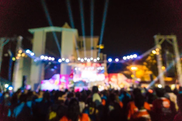 Blurred image of concert crowd in front of bright stage lights — Stock Photo, Image