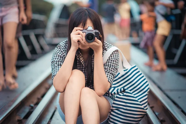 Asian women traveler photography with camera on rail way — Stock Photo, Image