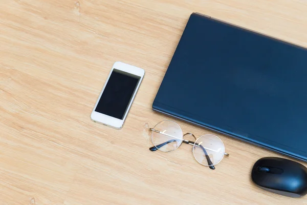 Ofis resepsiyon masası ile dizüstü bilgisayar cep telefonu ve gözlük — Stok fotoğraf