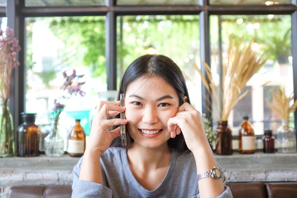 Hermosa Mujer Joven Asiática Usando Teléfono Celular Mientras Está Sentada —  Fotos de Stock