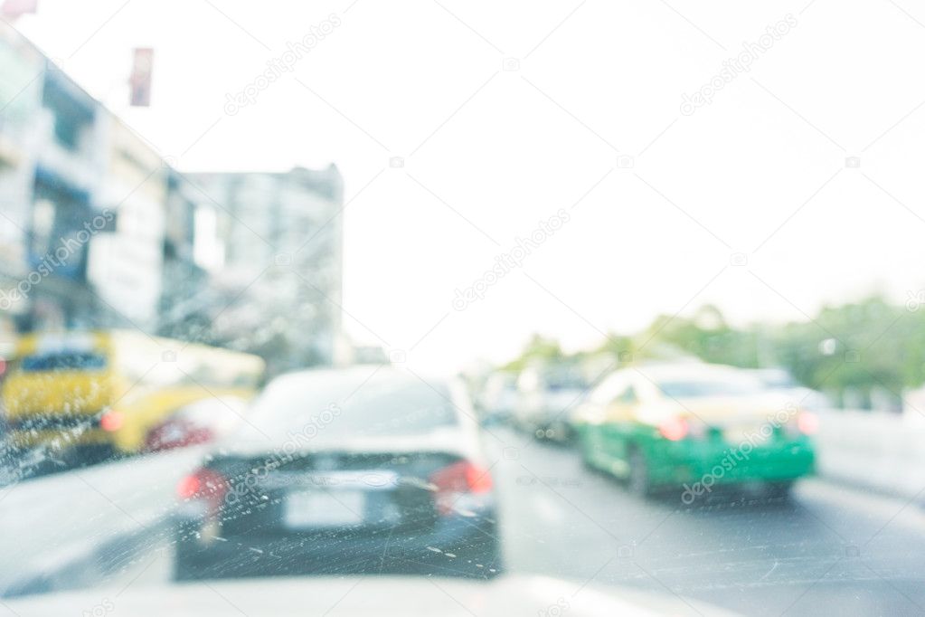 Defocused cars in city traffic jam in Bangkok city with sun ligh