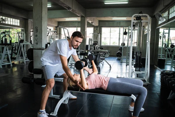 Couple of caucasian sport men women exercise partner in fitness gym sport healthy concept