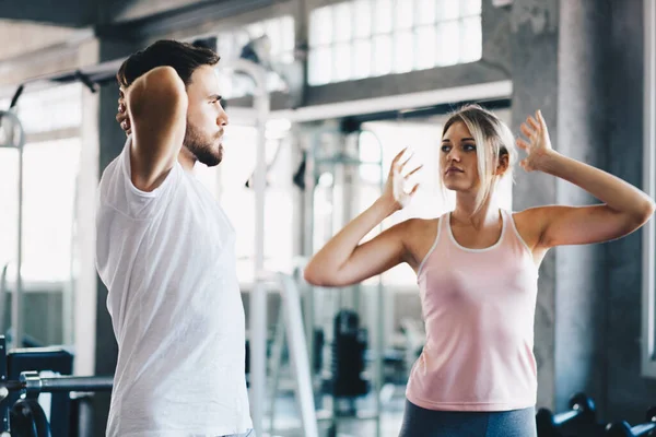 Sport couple stretching muscle before sport activity in fitness gym club happy exercise together