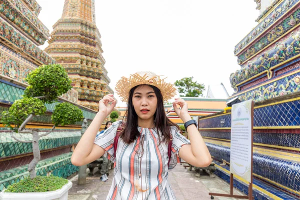 Beautiful asian tourist backpack women walking travel in buddhistm temple pagoda statue travel in. Bangkok Thailand