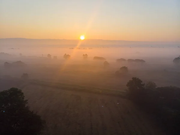 Morning sunrise misty on field silhouette nature countryside aerial view