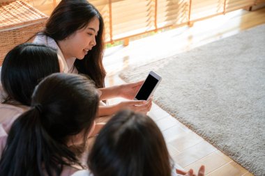 Ofisteki dijital akıllı telefon cihazları kullanan bir grup bayan arkadaş bilgi paylaşımı yapıyor