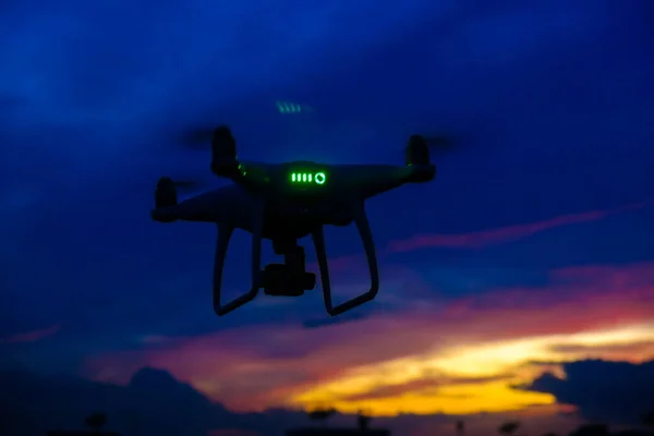 Drone flying over city building against colorful sky sunset landscape