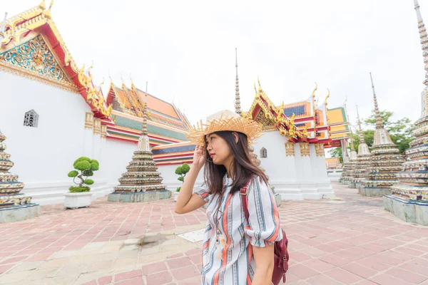 Young asian tourist women walking travel around buddhism temple of Bangkok Thailand