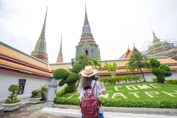Young asian tourist women walking travel around buddhism temple of Bangkok Thailand